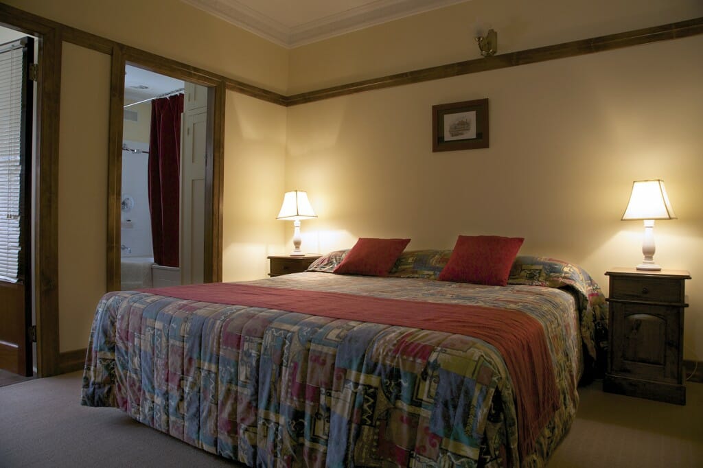 Furnished bedroom with reading lamps