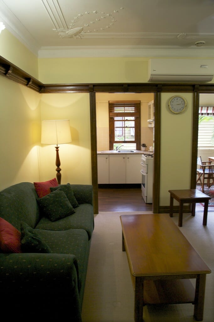 Suite living area with kitchen beyond